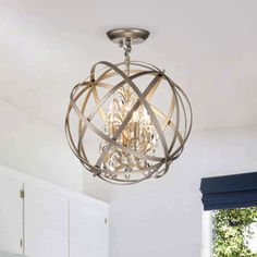 a chandelier hanging from the ceiling in a kitchen