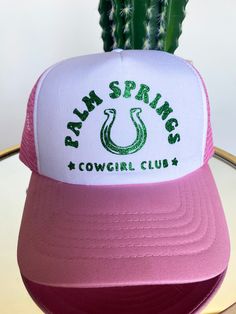 Pink and white front with mesh back adjustable snap trucker hat with Palm Springs Cowgirl Club in kelly green glitter embellishment. 100% Polyester Mesh Back 5-panel cap Seamless Front Panel with Lining 6 Rows Stitching on Visor Matching Fabric Undervisor Matching Color Sweatband Plastic Adjustable Snap Spring Trucker Hat, White Trucker Hat, Cowgirl Aesthetic, Cowgirl Jewelry, Cowgirl Hat, Glitter Design, Cowgirl Hats, Buy Buy, Green Glitter