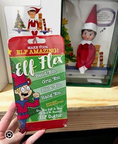 someone holding up an elf's gift card in their hand