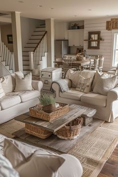 a living room filled with white furniture and lots of pillows on top of it's couches