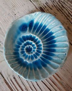 a blue bowl sitting on top of a wooden table