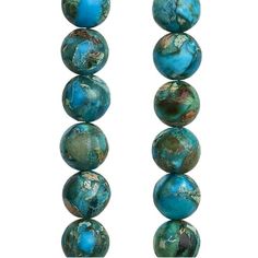 several turquoise colored beads are lined up on a white surface