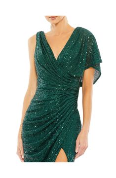 Dazzling emerald sequins illuminate this glamorous gown designed with a dipped cowl back and a daring side vent. 62 1/2" length V-neck Single short sleeve Lined Asian Owned/Founded 100% polyester Spot clean, dry flat Imported Party Gown With Ruched Bodice And Asymmetrical Neckline, Fitted Draped Dresses With Sequins, Green Evening Gown With Ruched Bodice, Green Sequined Evening Gown, Green Sequin Holiday Dress For Formal Occasions, Green Sequin Dress For Formal Holiday Events, Green Sequin Dress For Holiday Formal Occasions, Glamorous Evening Dress With Fitted Bodice And Asymmetrical Neckline, Party Gown With Pre-draped Asymmetrical Neckline