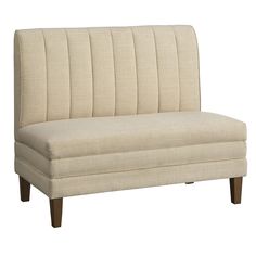 a beige couch sitting on top of a wooden frame