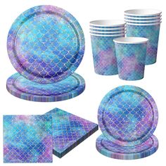 a blue and purple mermaid themed tableware set with matching plates, napkins and cups