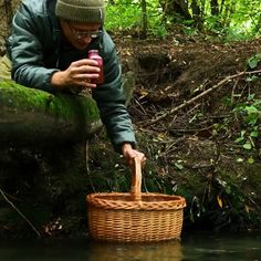 a man holding a basket in the water