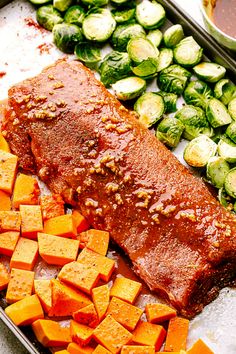 the food is prepared and ready to be cooked in the oven for dinner or asparagus, brussel sprouts, and carrots