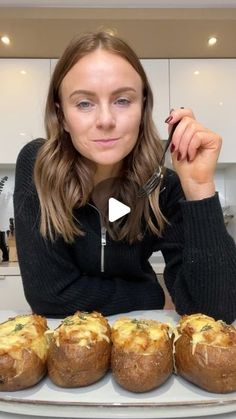 a woman sitting at a table with baked goods in front of her and the recipe on the plate