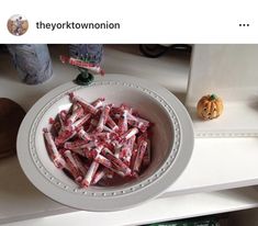 a white bowl filled with candy on top of a counter