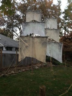 an old sailboat is sitting in the yard