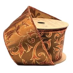 a roll of brown and orange ribbon with an intricate design on it's side