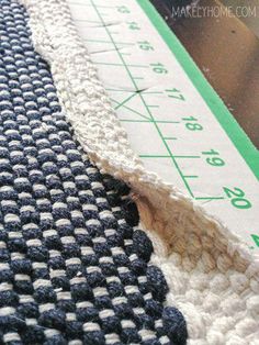 a close up view of a ruler and some knitted material on a table top