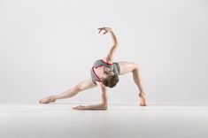 a woman is doing a handstand on the floor