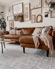 a living room filled with lots of furniture and pictures on the wall above it's couch