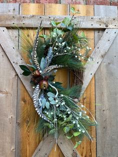 a wreath is hanging on the side of a wooden door