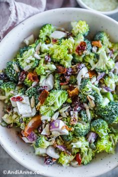 a white bowl filled with broccoli and other vegetables