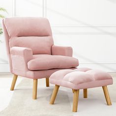 a pink chair and footstool in a white room