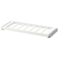 a white tray with four compartments on the bottom and one drawer in the middle for storing items