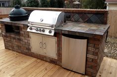 an outdoor bbq grill on a wooden deck