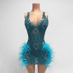 2-3 weeks processing and shipping time This hand beaded mini dress features beautiful rhinestone beading and feather details. The color coordinated back is a comfortable stretchy spandex material. If you want coverage in those special areas, Spanx, a bra, underwear, a slip or whatever you choose can be worn underneath. Color may vary due to lighting Material: polyester, elastane Care: hand wash or dry clean only Triangle Crop Top, Showstopper Dress, Feather Mini Dress, Beaded Mini Dress, Beaded Feather, Most Beautiful Dresses, Aqua Dress, Rhinestone Bead, Beaded Dress