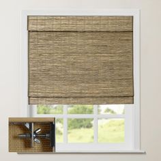 a window with a bamboo roman blind in front of it