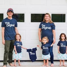 a man and two women standing with their children in front of a garage door wearing matching shirts that read the original