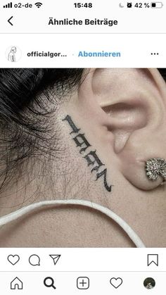 an ear tattoo with the word faith written on it