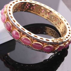 One (1) Pc Beautiful Pave Diamond With Ruby Bangle Bracelet- 925 Sterling Vermeil - Bangle With Lock - Bangle Bracelet BD047 Approx Measurement : Bangles Size: 2.25 inches inside diameter Silver Purity: 925 Metal: Sterling Silver Finish: Vermeil Stone: Ruby, 13mm Sold As: 1 Pc We are continuously adding new products in our store. So keep coming back to see more great deals on gems in our mart. Amazing quality at the best price around!!! Bulk wholesale orders are welcome on this item and any othe Luxury Round Ruby Bracelets, Luxury Round Ruby Bracelet, Classic Gemstone Bangle Jewelry, Pink Ruby Round Bracelets, Luxury Ruby Bracelet, Exquisite Bangle Bracelets For Anniversary, Classic Gemstone Bangle Bracelet, Fine Jewelry Ruby Bangle, Elegant Ruby Bangle Jewelry