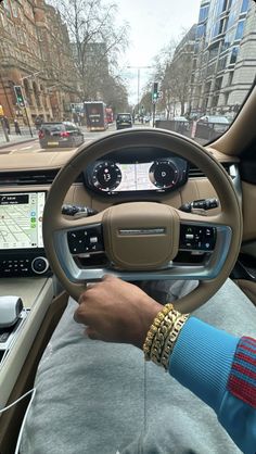 a man driving a car on a city street