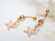 Starfish Belly Ring Show off your beautiful belly! Belly ring features a textured golden starfish charm with sparkly pink enamel accented with a hand wire wrapped pink opalite bead. Belly button ring measures 1 3/4 inches long total length. Barbell is 14g gold plated surgical steel with a 7/16" (11mm) wearable bar length. For Belly Button Rings: https://www.etsy.com/shop/AllAboutClass?section_id=18474235&ref=shopsection_leftnav_1  All body jewelry sales are final!!  AllAboutClass DOES NOT accept Pink Starfish Charm Jewelry, Pink Starfish Jewelry For Gift, Pink Star Jewelry With Starfish Charm, Pink Star-shaped Jewelry With Starfish Charm, Pink Starfish, Bellybutton Piercings, Starfish Jewelry, Gold Belly Ring, Jewelry Piercing