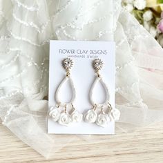 the white flower earrings are on display