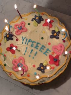 a birthday cake with lit candles on it