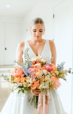 a woman holding a bouquet of flowers in her hands