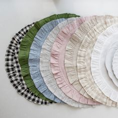 a bunch of plates that are sitting on a table together, all in different colors