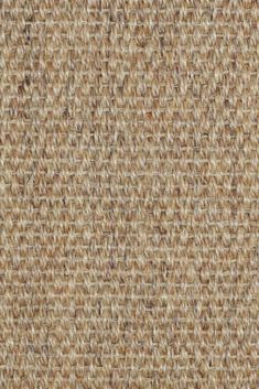 an up close shot of the texture of a woven fabric with brown and tan colors