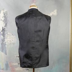 "This navy blue double-breasted blazer has notch lapels and padded shoulders, and closes in the front with one button (four in total show on the front). Three buttons decorate each sleeve cuff. The dark blue wool-blend jacket has three pockets on the front, and is fully lined in a navy blue satin viscose fabric (with two inner pockets). The fabric has a double pinstripe pattern, with a textured chevron herringbone running vertically as well. Brand label: Turo (Made in Finland) Size: 40 US/UK Mat Fitted Double-breasted Sport Coat With Notch Lapel, Fitted Notch Lapel Double-breasted Outerwear, Fitted Double-breasted Blazer With Lapel Collar, Fitted Double-breasted Business Outerwear, Blue Double-breasted Outerwear, Blue Double-breasted Suits For Business Casual, Fitted Blue Double-breasted Suit, Blue Double-breasted Suit With Button Closure, Tailored Nehru Jacket With Notch Lapel