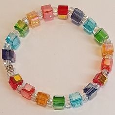 This beautiful rainbow crystal cube bracelet will add a pop of color to your favorite pride outfit.  The Arora borealis finish adds extra shine to these colorful cube crystals. Cheap Rainbow Plastic Stretch Bracelet, Multicolor Crystal Jubilee Bracelet, Iridescent Crystal Bracelets As Gift, Multicolor Crystal Bracelets For Gifts, Multicolor Crystal Beaded Bracelet Gift, Cube Bracelet, Pride Outfit, Rainbow Crystal, Nov 1