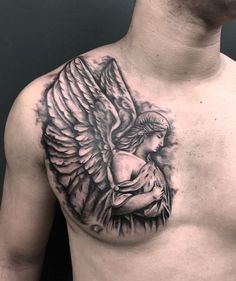 a man's chest with an angel tattoo on it