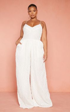 Get ready to meet your new season partner doll. Featuring a white devore material with a cup detail and wide leg fit, what's not to love Earn some extra style points this season and team with gold accessories and statement heels.   Length approx 157.5cm/62 (Based on a sample size UK 16)   Model wears size UK 16/ EU 44/ AUS 16/ US 12   Model Height - 5ft 7 Plus Size Reception Outfit, Plus Size Ibiza Outfits, Plus Size Hen Do Outfit, Old Money Fashion Plus Size, Plus Party Outfit, All White Outfit Plus Size, Plus Size Wedding Jumpsuit, White Outfit Plus Size, Plus Size White Jumpsuit