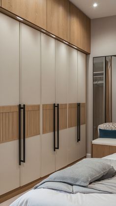 a bed sitting in a bedroom next to a tall cabinet with doors on each side