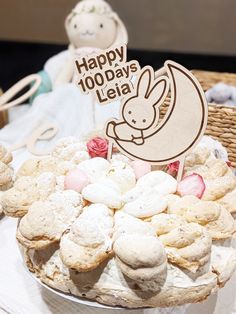 a cake with cookies and marshmallows in it on a table next to a teddy bear