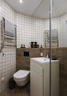 a white toilet sitting next to a bathroom sink