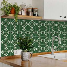 a green tile backsplash in a kitchen with white cabinets and wooden countertops