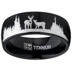 a black and white wedding band with an image of two deer in the woods on it