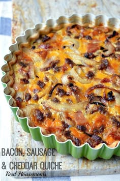 bacon, sausage and cheese quiche in a tart dish on a table with text overlay