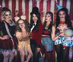 a group of women in costumes posing for a photo