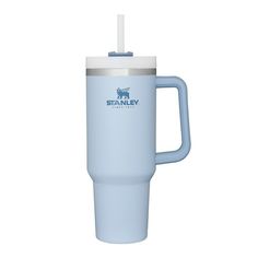 the stanley travel mug is light blue with a white lid and straw in front of it