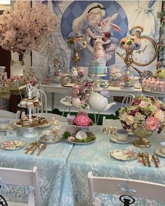 a table topped with lots of cake and flowers