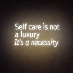 a neon sign that says self care is not a luxury it's a necessity