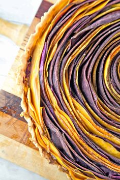 a close up of a pie on a cutting board